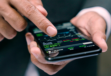 Man views market information on his mobile phone